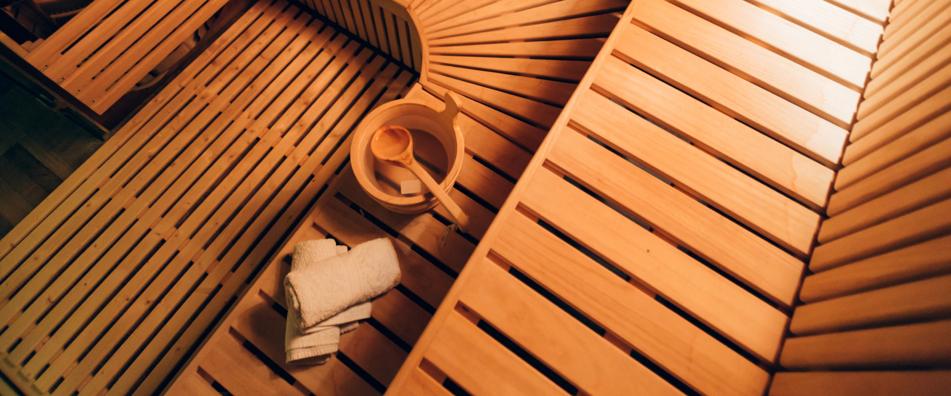 top shot of clean sauna with bucket and towels